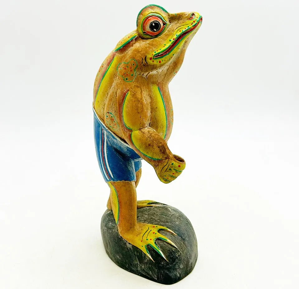 Fun hand painted wooden carved frog figure standing with a basket